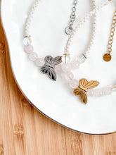Load image into Gallery viewer, Bracelet with butterfly charm on a white dish