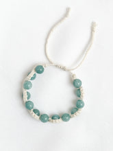 Load image into Gallery viewer, Bracelet with light blue beads on a white background