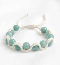 Load image into Gallery viewer, Bracelet with light blue beads on a white background
