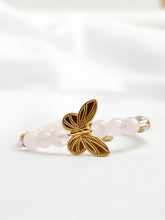 Load image into Gallery viewer, Bracelet with gold butterfly charm and clear beads on a white background