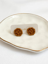 Load image into Gallery viewer, Brown macrame earrings on a white dish with a visible brand label.