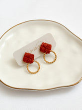 Load image into Gallery viewer, Macrame pair of earrings with gold hoops on a white dish