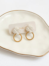 Load image into Gallery viewer, Macrame pair of earrings with gold hoops on a white dish