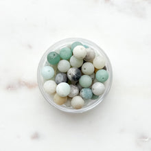Load image into Gallery viewer, Beads in a clear container on white background
