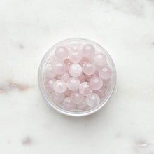 Load image into Gallery viewer, pink beads in clear container on white background
