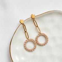 Load image into Gallery viewer, Gold and beige hoop earrings on a white plate with a white background
