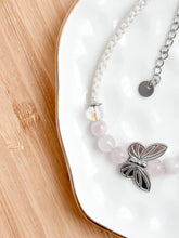 Load image into Gallery viewer, Bracelet with butterfly charm on a white surface
