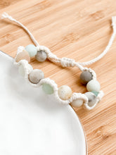 Load image into Gallery viewer, Bracelet with beads on a wooden surface
