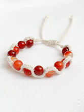 Load image into Gallery viewer, Bracelet with red and orange beads on a white background
