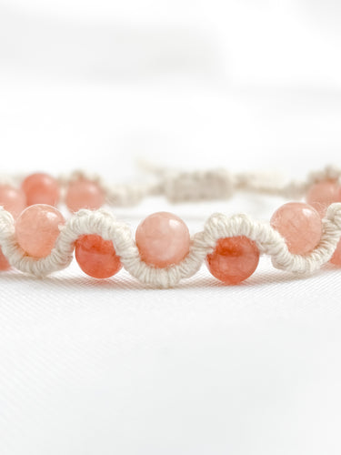 Bracelet with pink beads on a white background