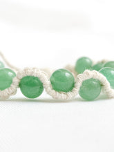 Load image into Gallery viewer, Green beaded bracelet with white macrame cord on a white background
