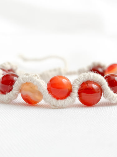 Bracelet with red beads on a white background