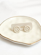 Load image into Gallery viewer, Pair of white macrame earrings on a branded card, displayed on a decorative plate.
