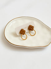 Load image into Gallery viewer, Macrame pair of earrings with gold hoops on a white dish
