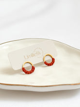 Load image into Gallery viewer, gold hoop earrings on a white plate
