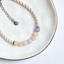 Load image into Gallery viewer, Bracelet with pastel beads on a white plate
