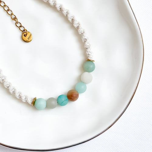 Bracelet with multicolored beads on a white plate