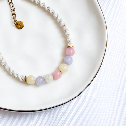 Bracelet with pastel beads on a white plate