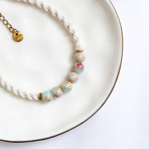bracelet with natural stone beads on a white plate